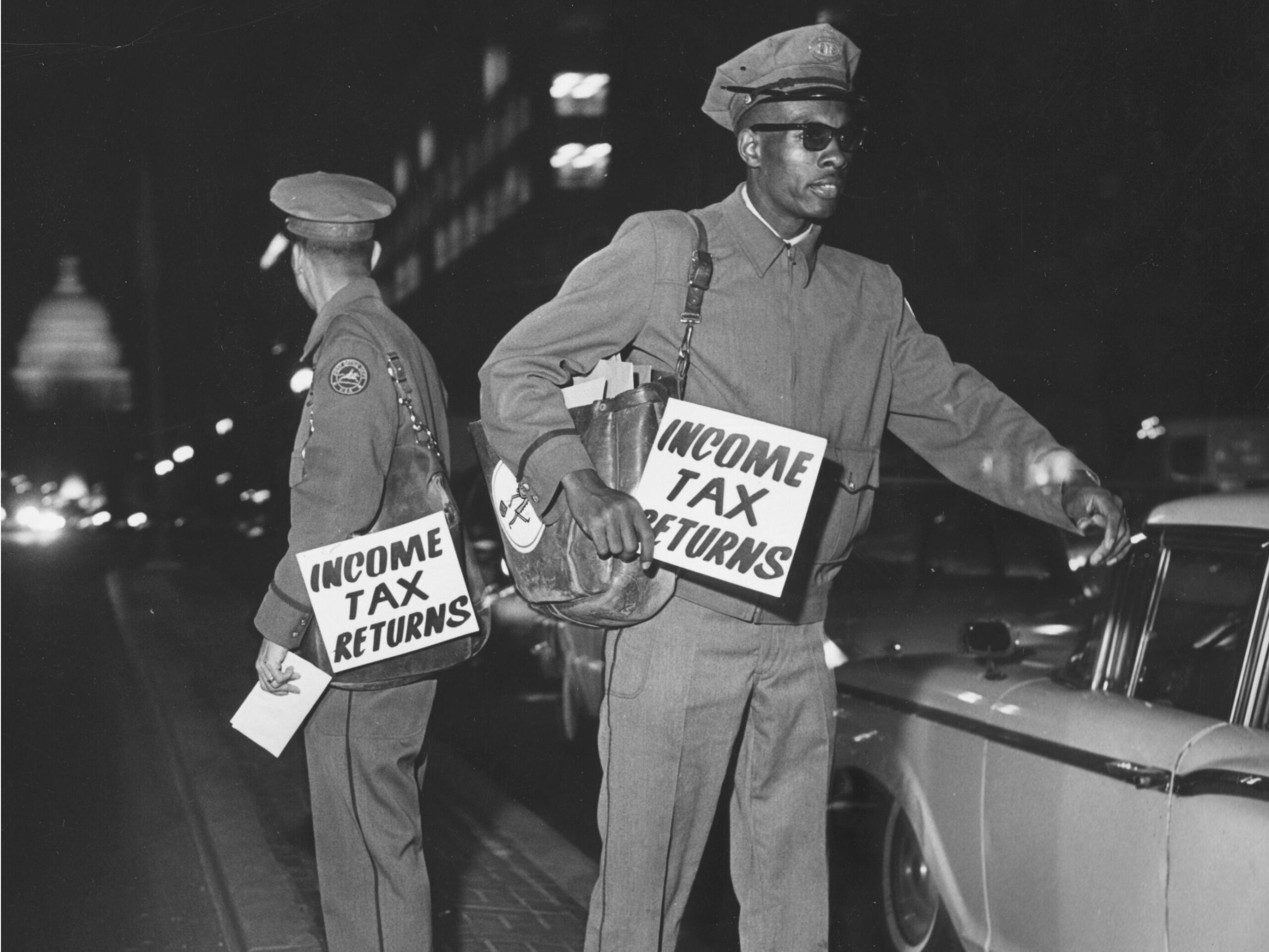Postal workers in Washington, DC, take drivers' tax returns the night they're due in 1955. Keystone/Getty Images